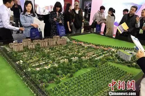 "Data Map: People are consulting at a real estate booth. <a